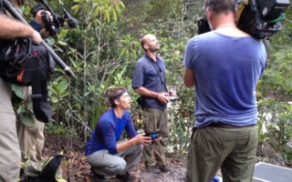 an image of men using camera equipment whilst filming in the Guyanan jungle