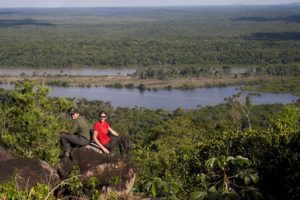 an image of two brave Bushmasters adventurers sitting on rocks amongst the rainforest