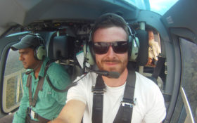 an image of a man posing for the camera in a helicopter