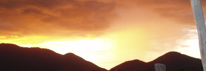 an image of hills in the distance during sunset