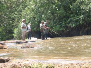 an image of men fishing in the river whilst taking part in our Jungle Survival course
