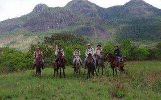 an image of men riding horses on the Bushmasters Ranch Venture